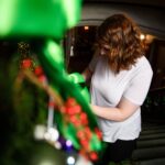 Karen Baker decorates along the grand stairwell at the Callanwolde Fine Arts Center in Atlanta on Tuesday, Nov. 20, 2018.