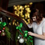 Karen Baker decoarates part of the grand staircase at the Callanwolde Fine Arts Center in Atlanta on Tuesday, Nov. 20, 2018. (AJ Reynolds/Brenau University)