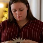 Morgan Davis works to create handmade ornaments for a Christmas tree at the Callanwolde Fine Arts Center in Atlanta on Tuesday, Nov. 20, 2018.