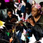 girl student placing butterfly on tree in burd