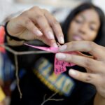 close up of student placing butterfly