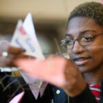 student looks at her butterfly