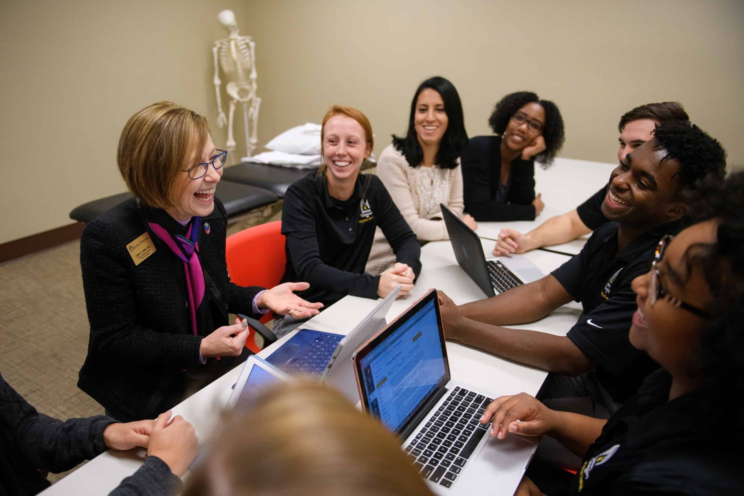 Linda Kern, dean of library sciences, talks with a group of physical therapy students about utilizing the library's resources in their research. (AJ Reynolds/Brenau University)