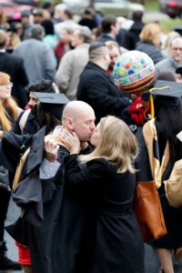 Graduate degree recipients celebrate with their families after the first ceremony on Friday, Dec. 13.