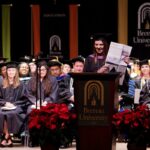 student holding up paper as she gives speech