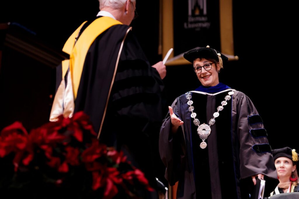 president looks at student on stage