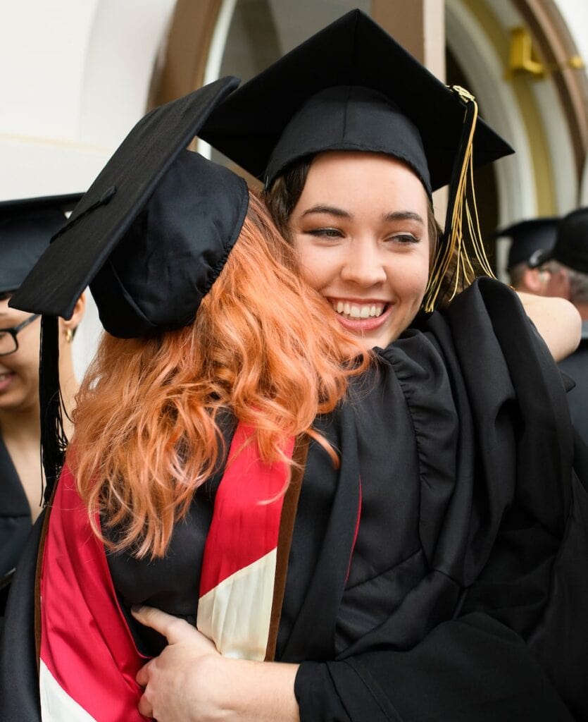 student hugging another student