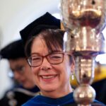 professor holding staff that is used for graduation