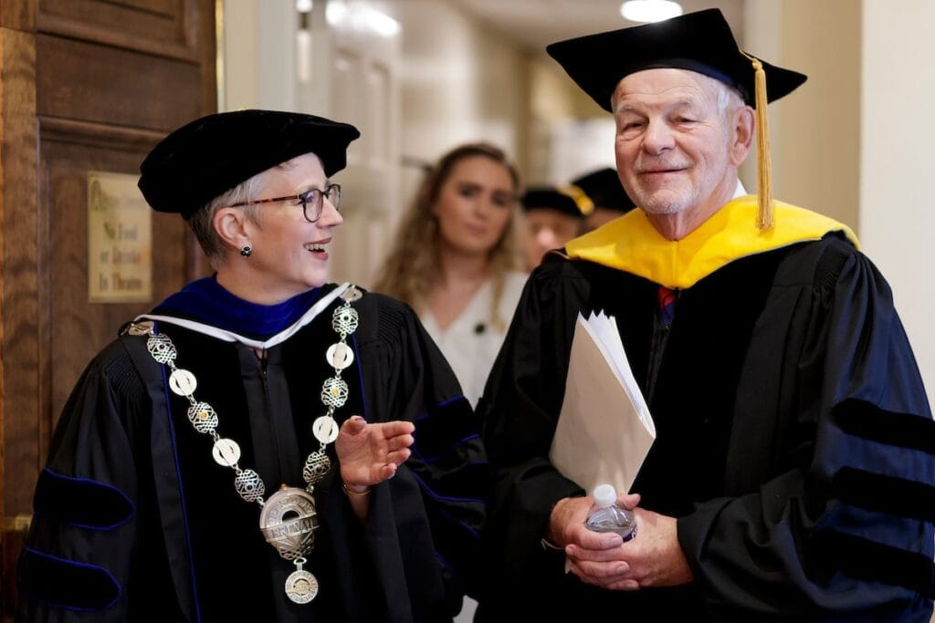 President talking with other faculty members