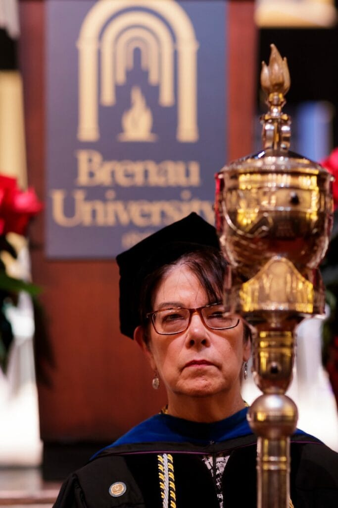Professor carries graduation staff into the ceremony