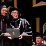 student recives diploma from the president