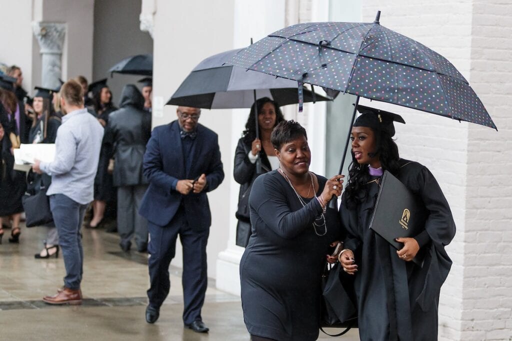 Graduates and their families walk under umbrellas during the Brenau University Graduate Commencement ceremony on Friday, Dec. 14, 2018 in Gainesville, Ga. (AJ Reynolds/Brenau University)