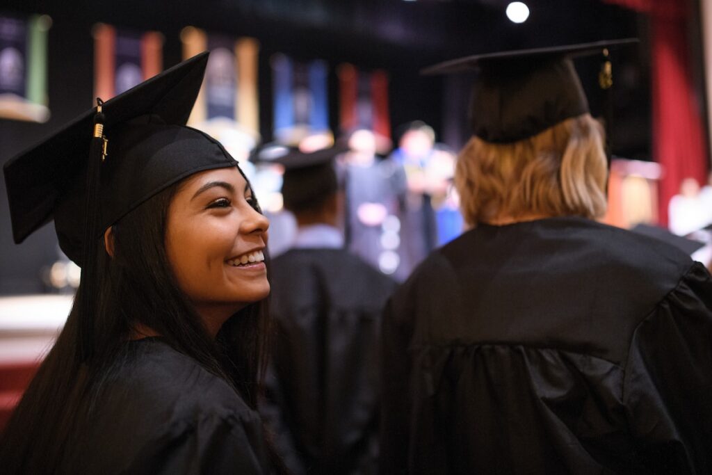 Jensen Meaux looks around after processing into Pearce Auditorium during the Brenau University Undergraduate Commencement ceremony on Friday, Dec. 14, 2018 in Gainesville, Ga. (AJ Reynolds/Brenau University)