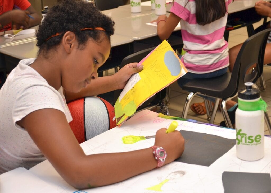 Aalliyah Glasper works on a story she wrote titled “Arizona” and a poster to accompany it during the RISE Summer Program.