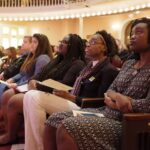 From left: Brenau University Provost Jim Eck and students Cynthia Ayala-Mata, Sahara Outler, Diamond Wood and Kenya Hunter listen to the keynote speech during the Winter Convocation in observance of Dr. Martin Luther King Jr. Day. (Nick Bowman for Brenau University)