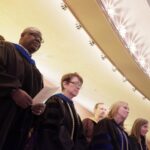 Brenau University faculty members George Demuyakor, Ann Demling, Debra Dobkins and Andrea Birch listen to the Gospel Choir during the 2018 Winter Convocation in observance of Dr. Martin Luther King Jr. Day on Thursday, Jan. 18, in Pearce Auditorium. (Nick Bowman for Brenau University)