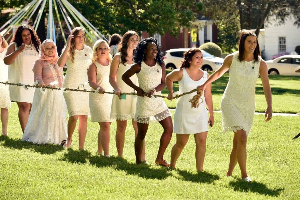 Women's College underclassmen carry an ivy and daisy chain while paying homage to the senior class on May Day. (Photo Barry Williams)