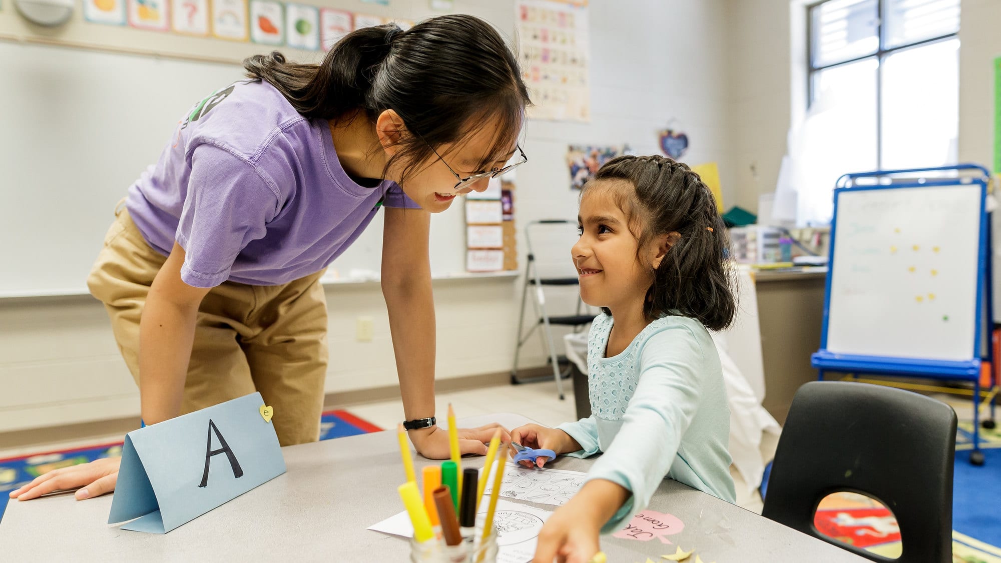 An education student works with a child on a school assignment