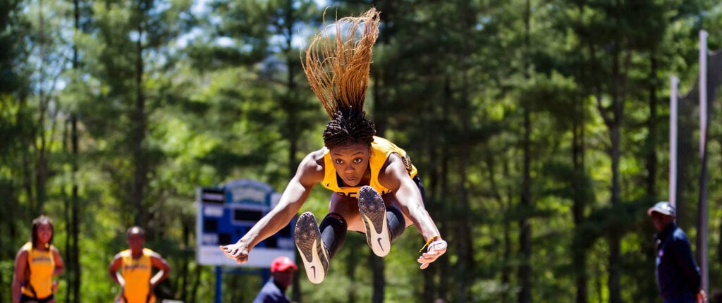 Brenau student athlete performing in long-jump