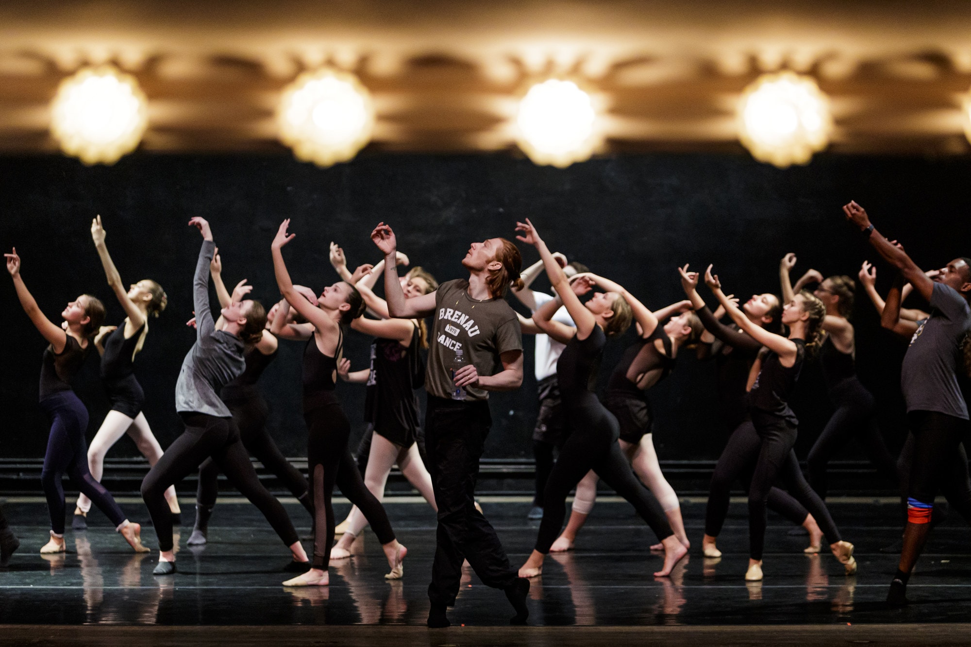 Dancers perform on stage with Nicholas Palmquist