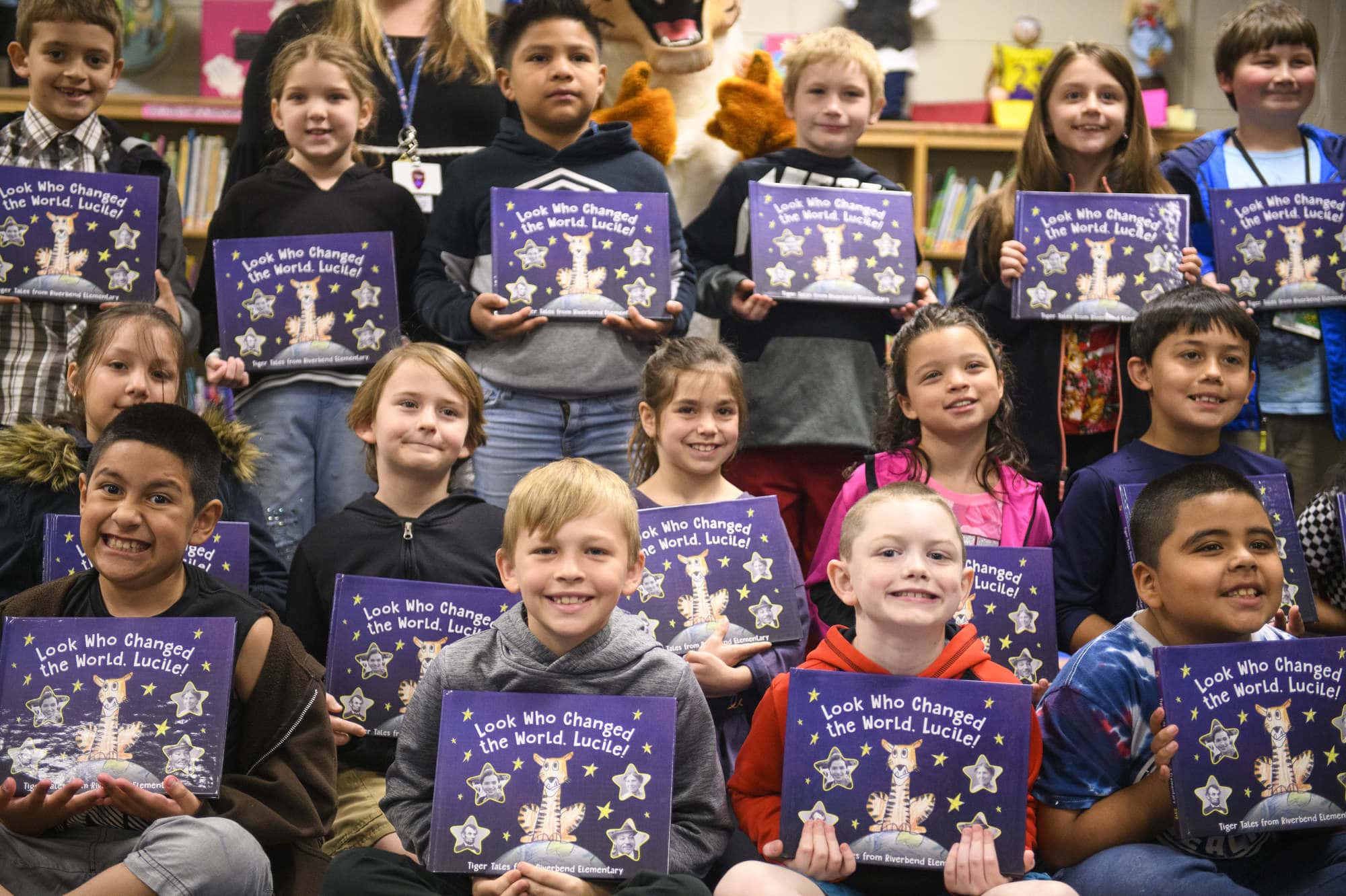Elementary school students take a photo with their published Tiger Tales books