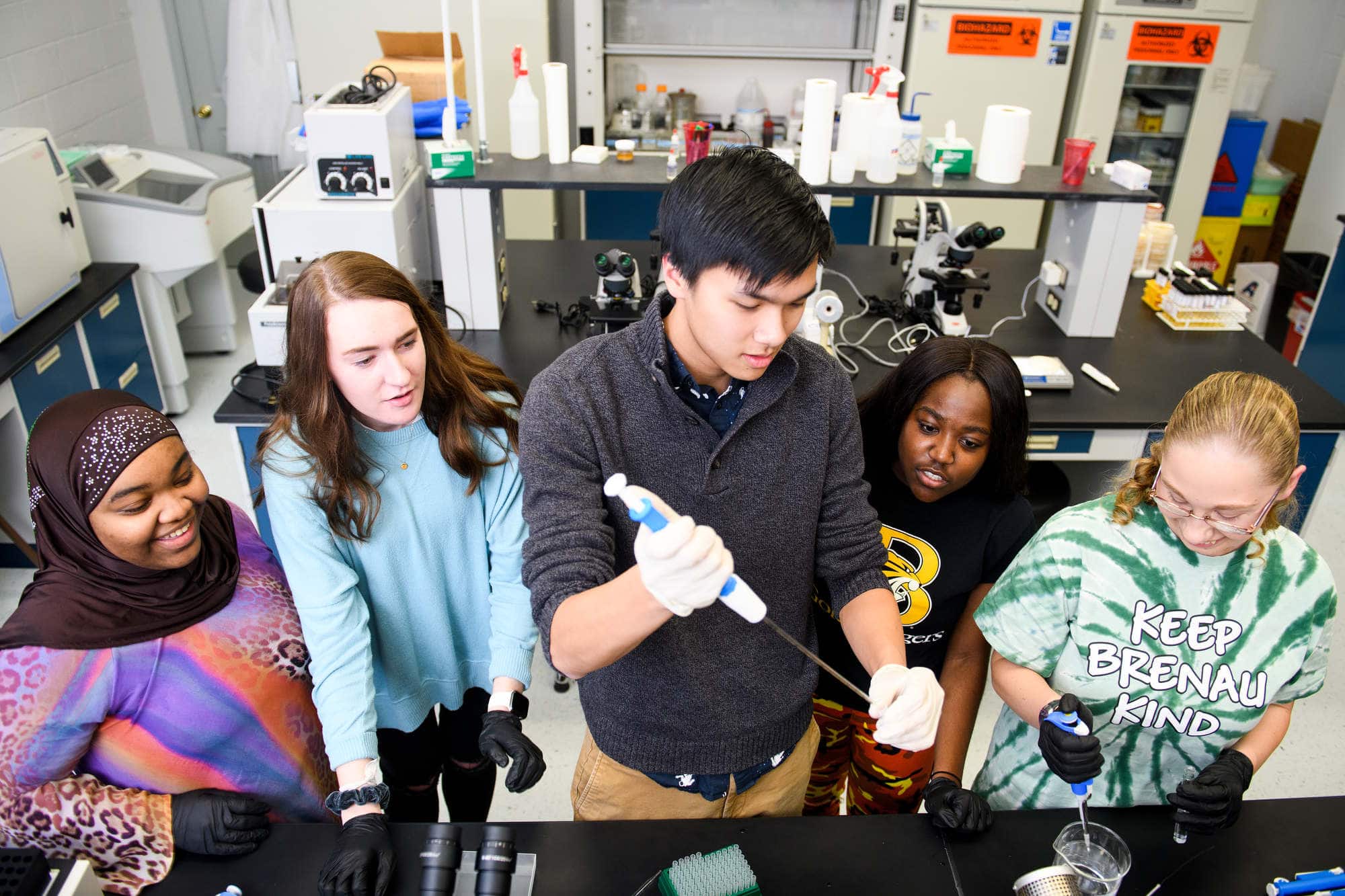 Five students work in a biology lab