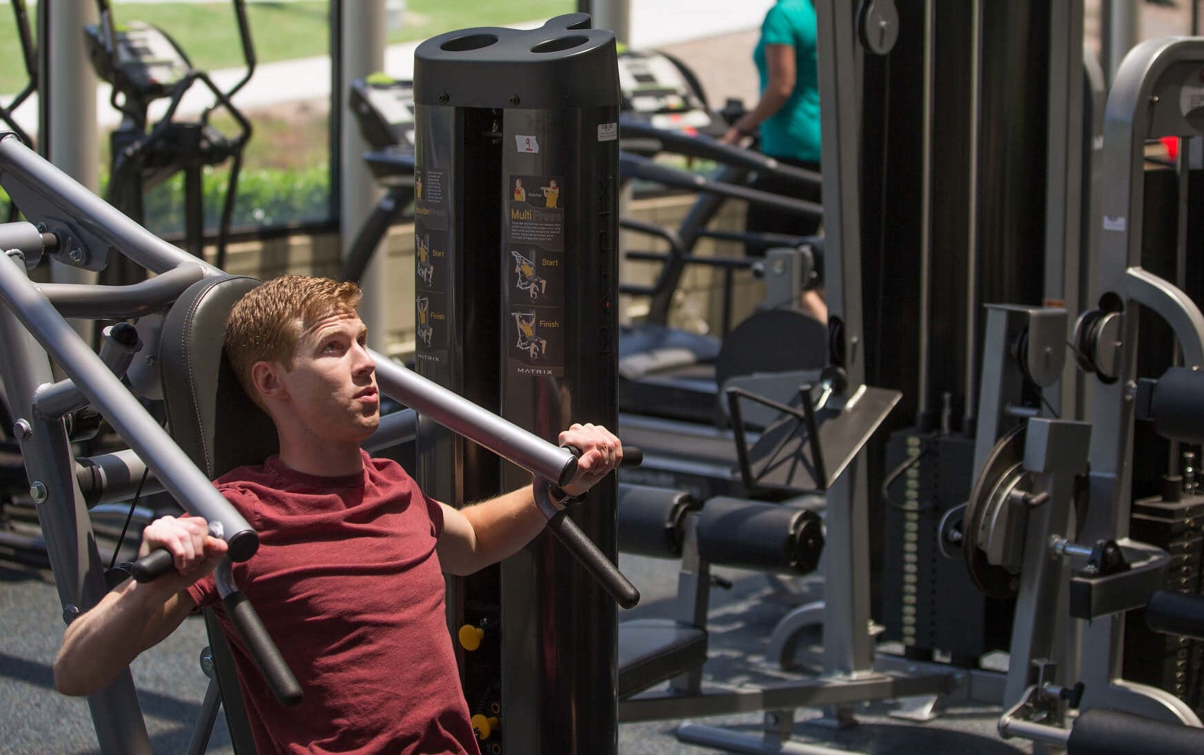 A student uses a weight machine