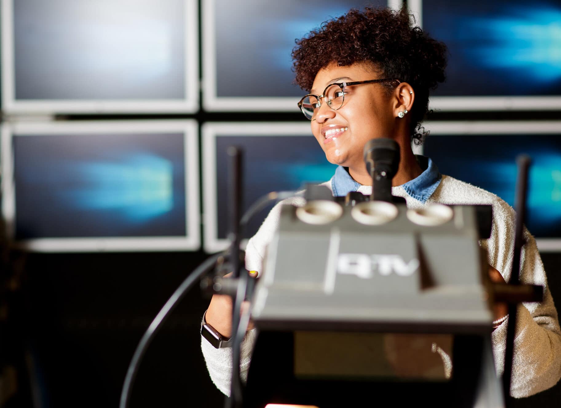 A student operates a television camera in Brenau's TV studio