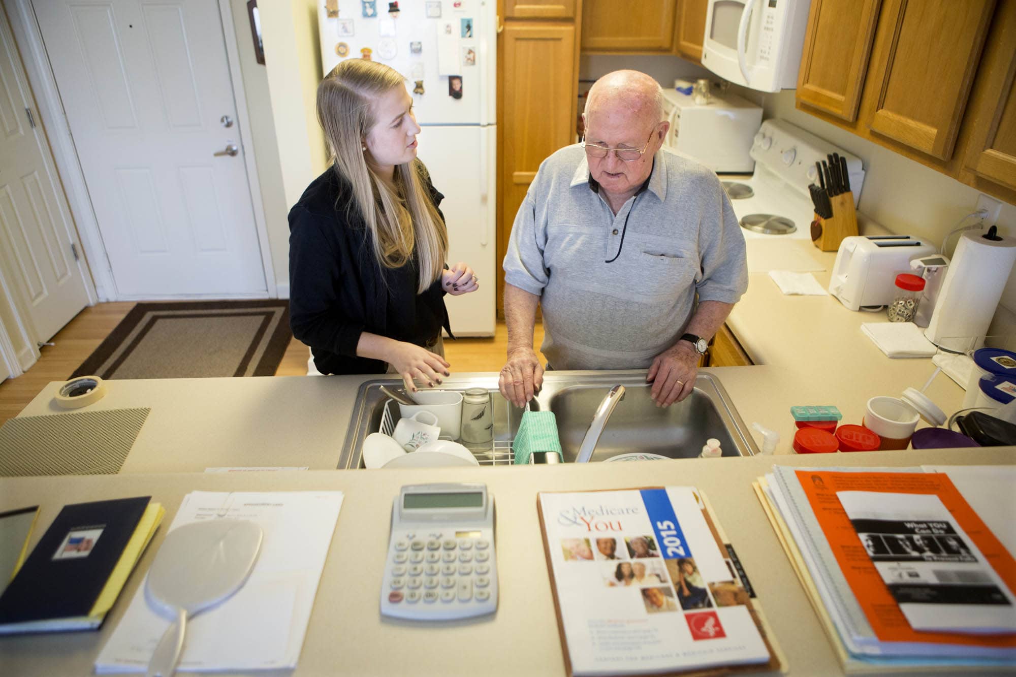 OT student helping elderly man