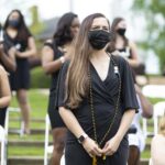 Students stand during the nursing pinning.