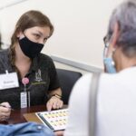 A student in Brenau's OT program helps out at the Caregiver Assistance and Resource Event (CARE) Fair.