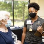 A student in Brenau's OT program helps out at the Caregiver Assistance and Resource Event (CARE) Fair.