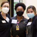 Three Brenau OT students stand together.