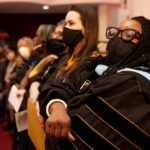 Faculty and staff hold hands at the MLK Jr Convocation