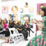 Women listen to speaker in gallery during Executive Women's MBA residency in NY