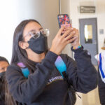 Panamanian student takes photo with her phone