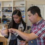 Professor Huy Chu works with Panamanian student in sculpture studio