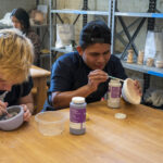 Panamanian students glaze clay works in sculpture studio