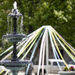 Fountain with May pole behind it