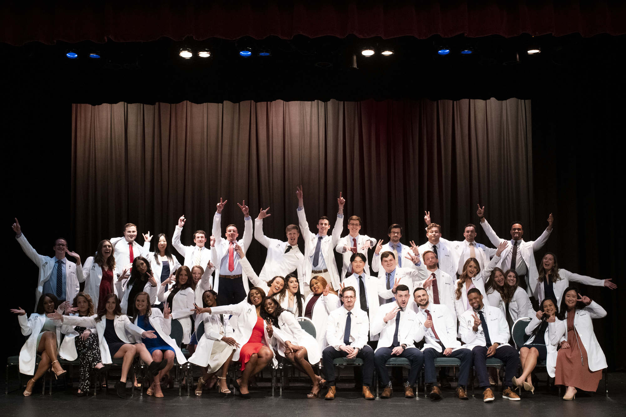Physical therapy doctoral students pose for a photo after receiving their white coats