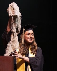 Haley Bartoletta shares a story about vulnerability with her baby blanket as a prop during the 2022 spring commencement