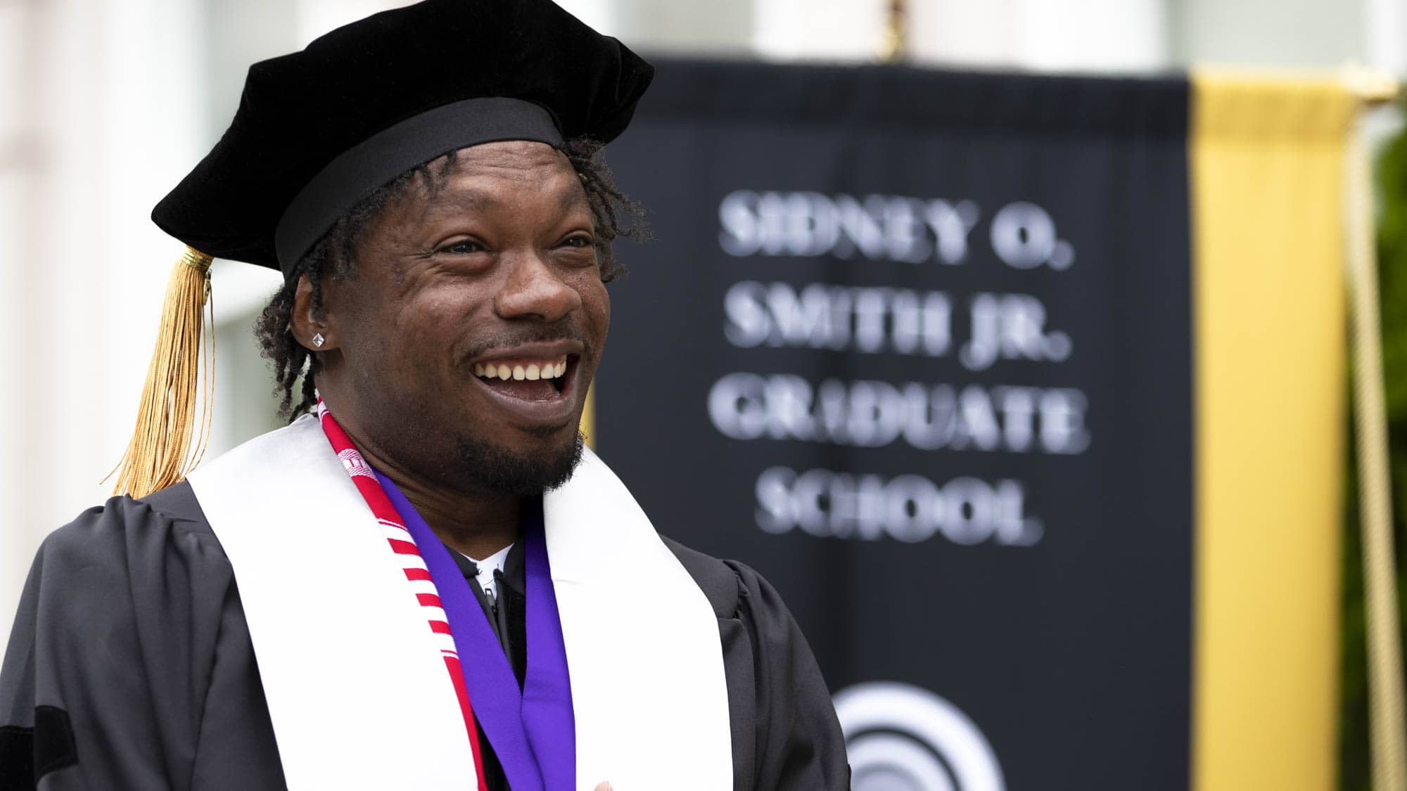 LaDonnis Perry walks across the stage at graduation