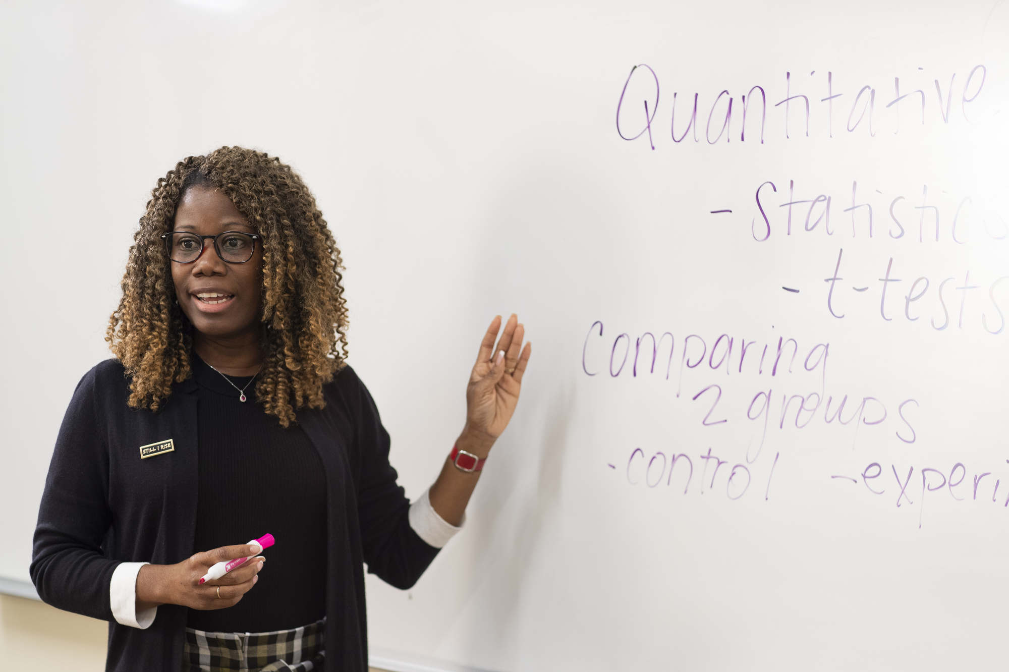 An education student teaches at a whiteboard