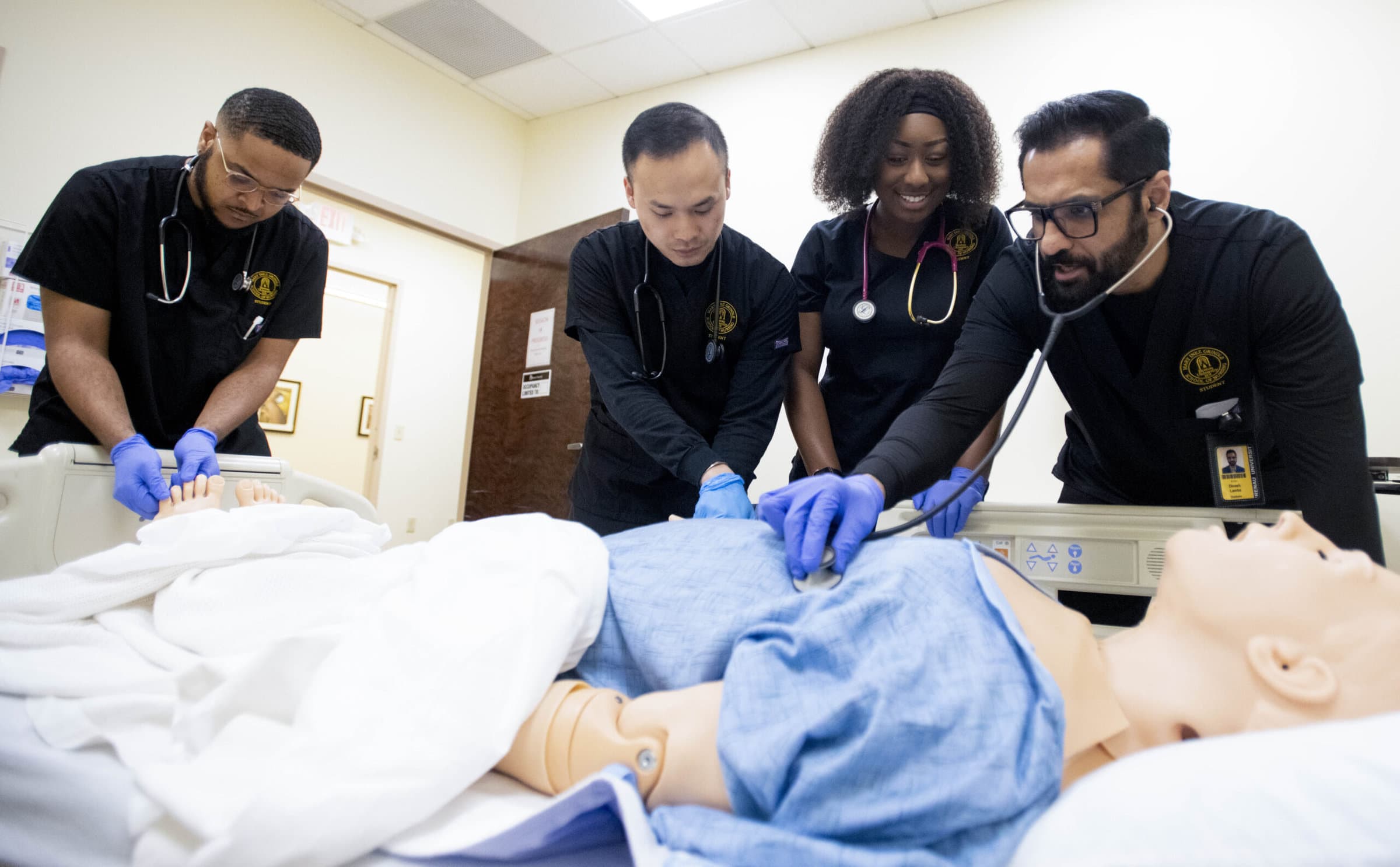 Nursing students practice on a simulation mannequin