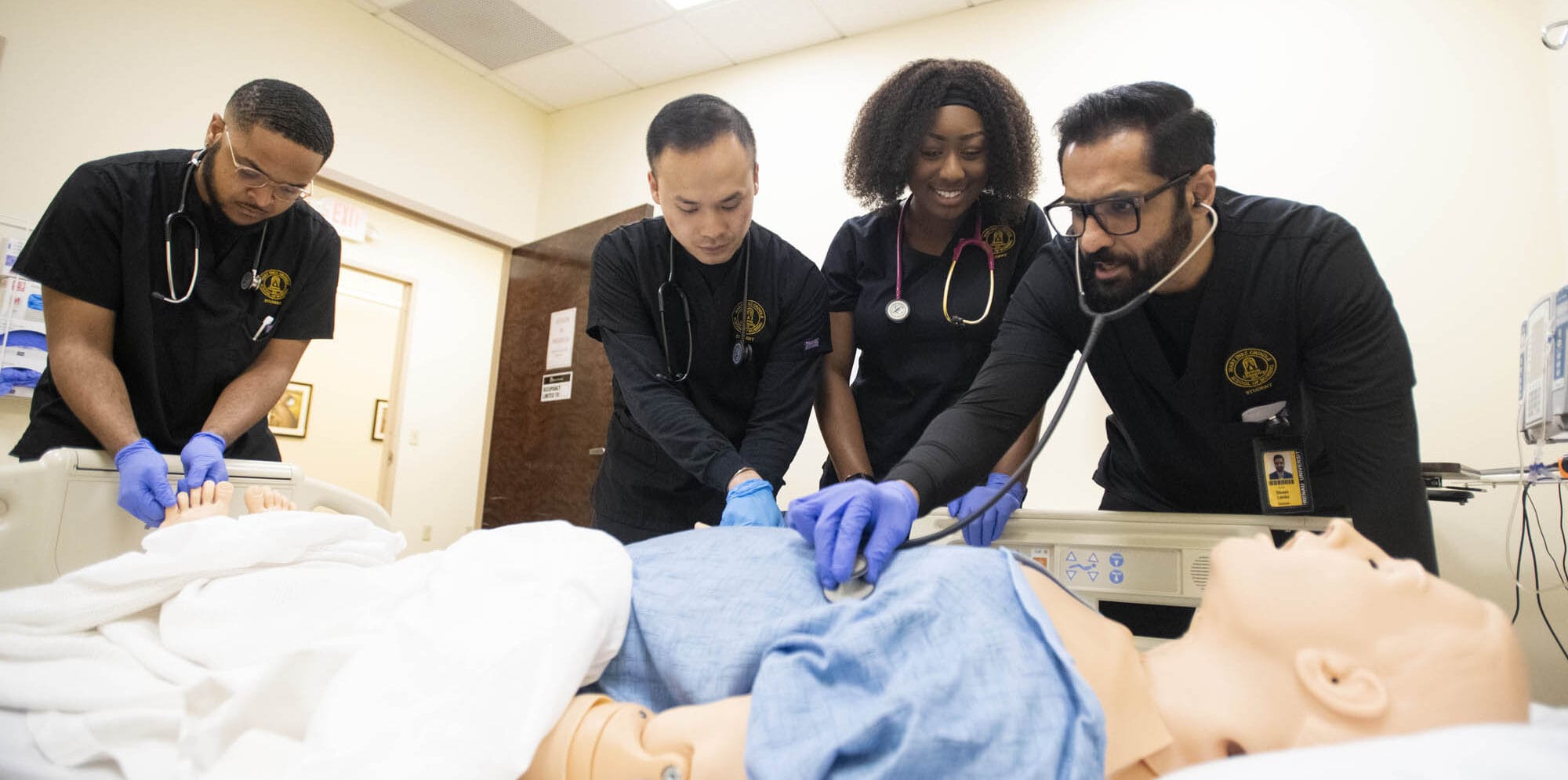 Nursing students over simulation mannequin