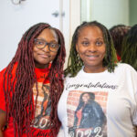 A student and her mother pose for a photo in her dorm room.