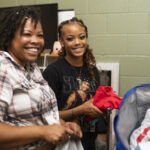 A new student unpacks her belongings with her family.