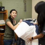 A freshman student and her mother unpack in Crudup Hall.