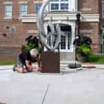 worker installing statue