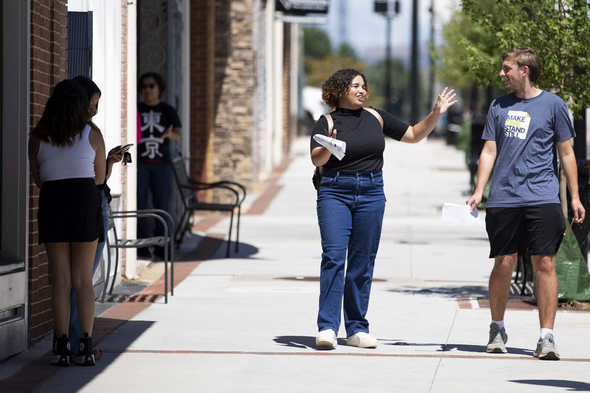 Two students walk on the Gainesville square